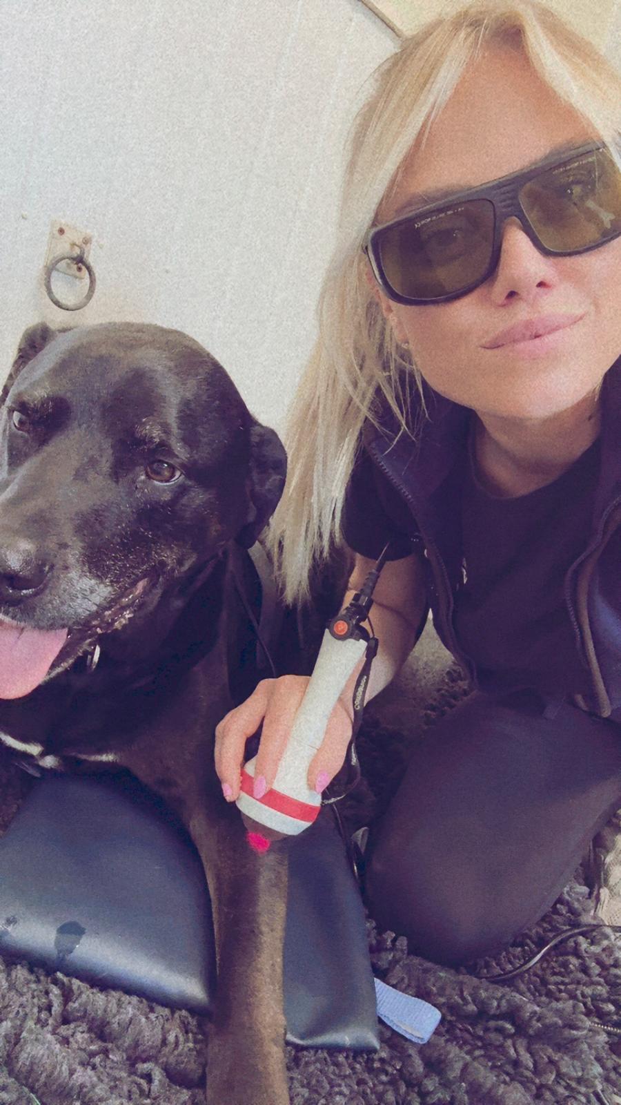 Amanda Butler smiling with a dog